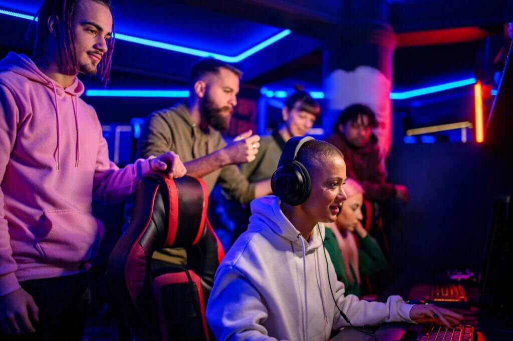 Diverse team of pro gamers playing in a multiplayer video game in a gaming club