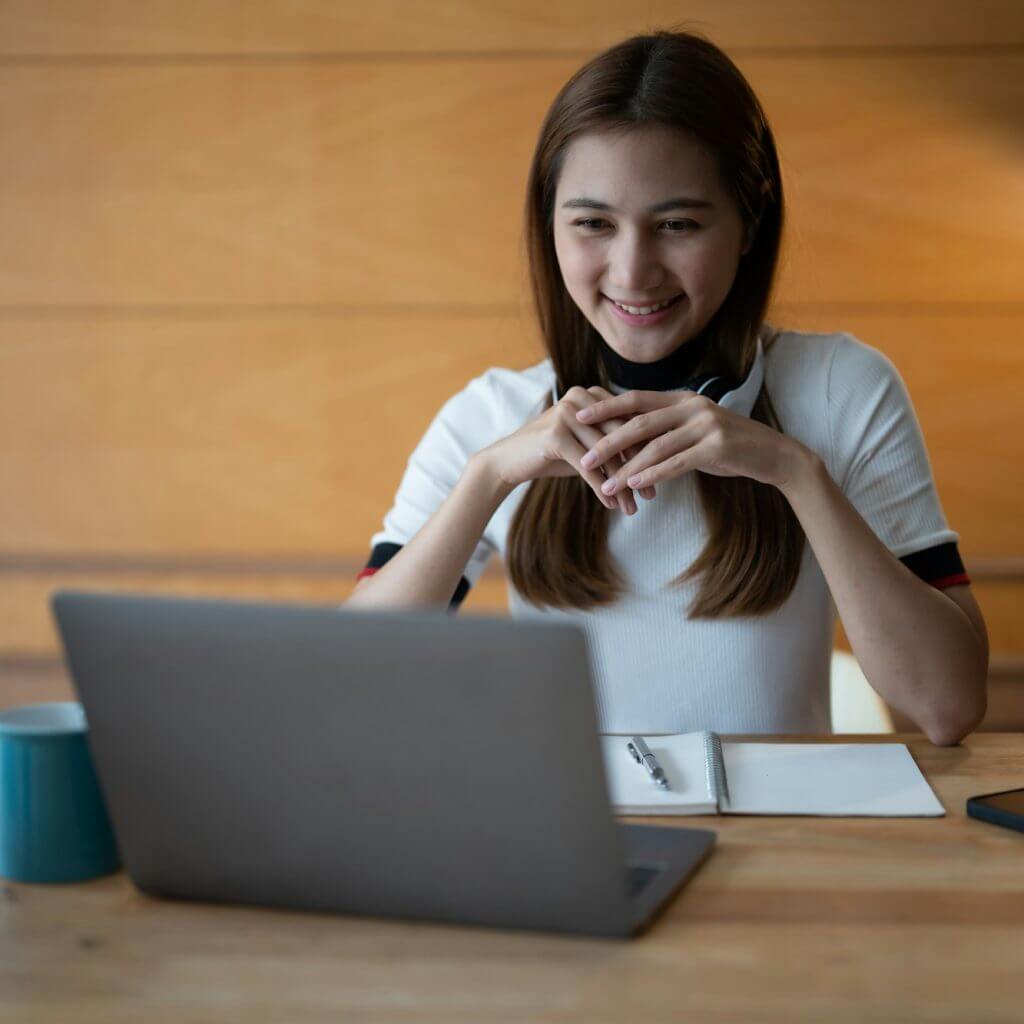 Asian woman working or learning on laptop indoors- educational course or training, seminar