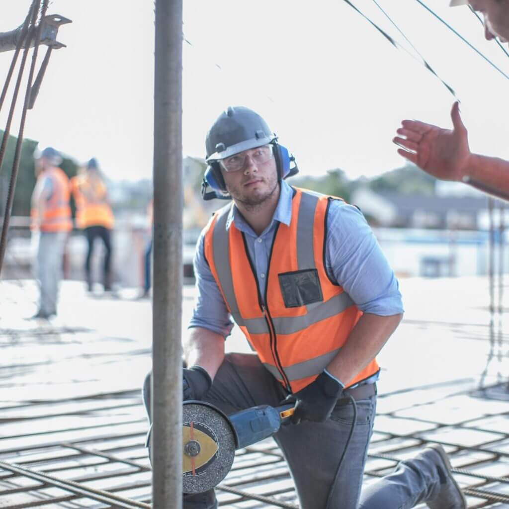 Site manager explaining to builder on construction site